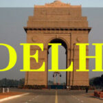 India Gate, one of the iconic places to visit in Delhi, with bold yellow 'DELHI' text overlayed on the image.