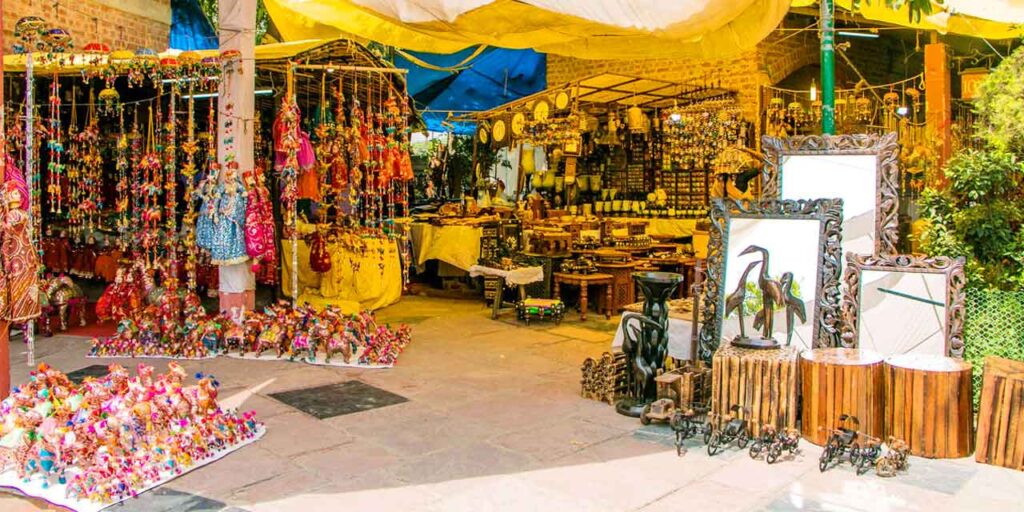 Vibrant stalls and handicraft shops at Dilli Haat displaying traditional Indian textiles, jewelry, and handicrafts