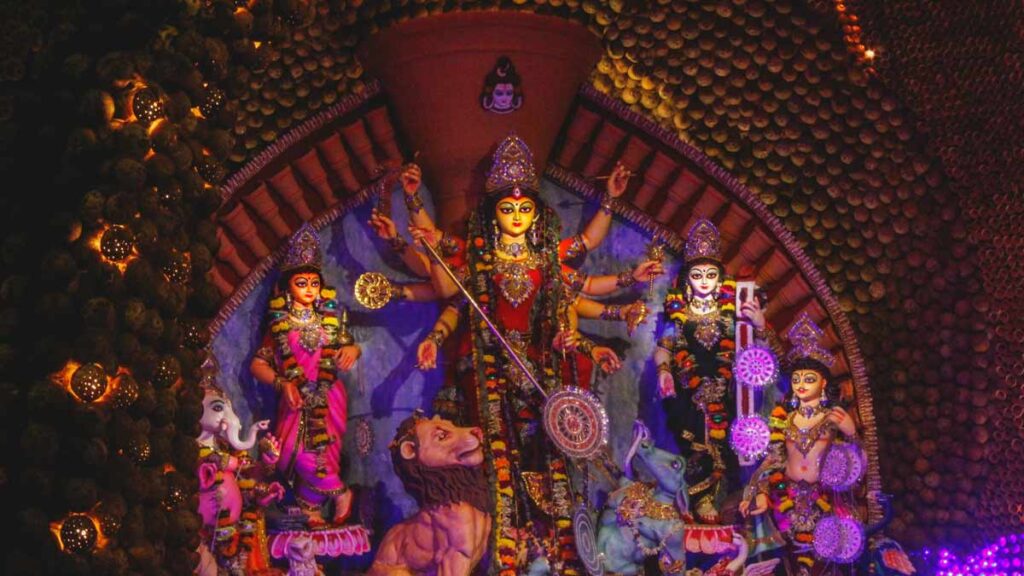 Durga Puja celebrations at Chittaranjan Park, Delhi, with vibrant pandals, beautifully adorned goddess idols, and crowds enjoying the festive atmosphere