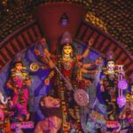 Durga Puja celebrations at Chittaranjan Park, Delhi, with vibrant pandals, beautifully adorned goddess idols, and crowds enjoying the festive atmosphere