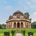Historic tomb surrounded by lush greenery at Lodhi Gardens, Delhi.