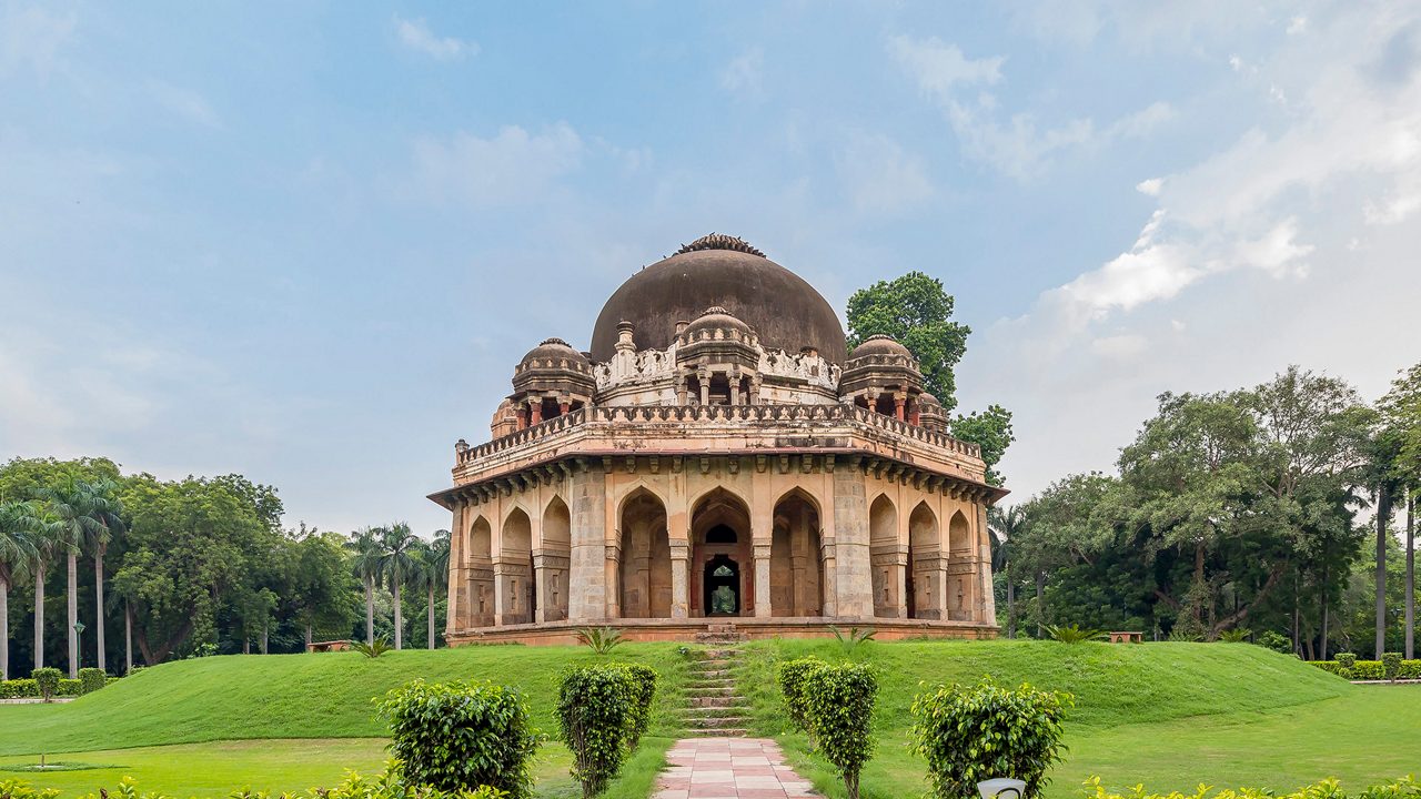 Historic tomb surrounded by lush greenery at Lodhi Gardens, Delhi.